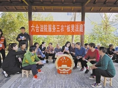  圖③：干警向附近農(nóng)戶解讀相關(guān)法律法規(guī)。