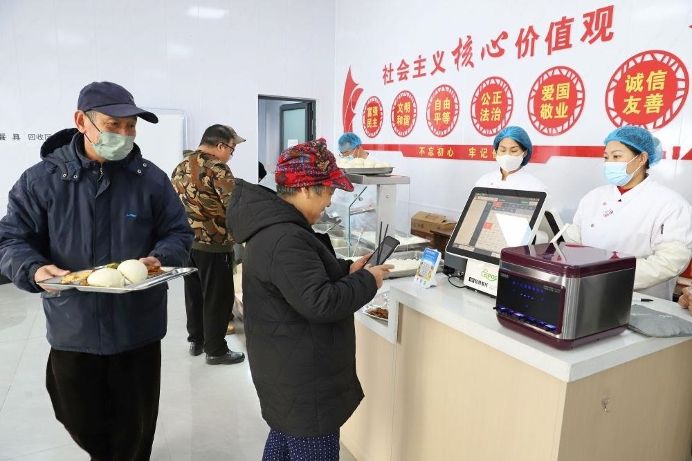 △2024年2月1日，市民在河北涿州市雙塔街道永濟(jì)秀園小區(qū)便民食堂內(nèi)購(gòu)買午餐。